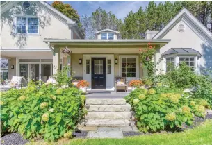  ?? TYLER MCKEAG PHOTOS ?? This two- storey home near Newmarket has a stucco façade, large windows, a covered patio and a double- car attached garage.