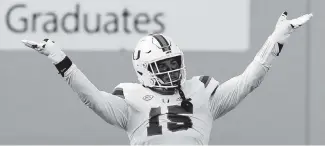  ?? MATT GENTRY | THE ROANOKE TIMES (AP Photo / MATT GENRTY, The Roanoke Times, Pool) ?? The Hurricanes’ Jaelan Phillips celebrates a defensive stop during the second half of Saturday’s game against Virginia Tech in Blacksburg, Virginia.