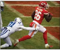  ?? AP/CHARLIE RIEDEL ?? Kansas City Chiefs running back Damien Williams scores a touchdown as Indianapol­is Colts cornerback Quincy Wilson pursues during the first half of Saturday’s AFC divisional playoff game in Kansas City, Mo. Williams ran for 129 yards on 25 carries.