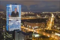  ?? Elena Ignatyeva/Associated Press ?? An electronic screen, installed on the facade of a business tower, shows Russian President Vladimir Putin speaking during his annual state of the nation address Wednesday in St. Petersburg, Russia.