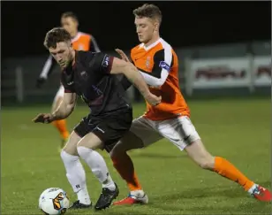  ??  ?? Lee Duffy of Wexford F.C. holding off an Athlone Town opponent.