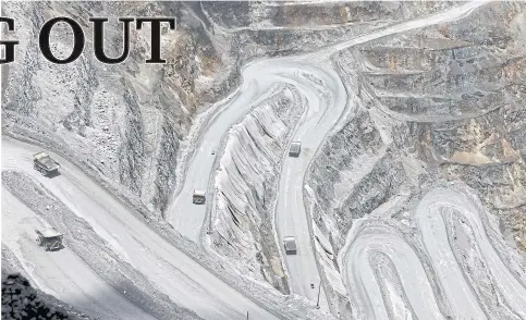  ??  ?? Trucks navigate the roads that snake down the slopes of the PT Freeport Grasberg open-pit copper and gold mine near Timika in the eastern region of Papua, Indonesia.