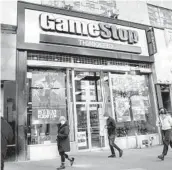  ?? JOHN MINCHILLO/AP ?? Short-sellers, including hedge funds, had wagered recently that shares in GameStop would fall while its mall-heavy business continued to shrink.