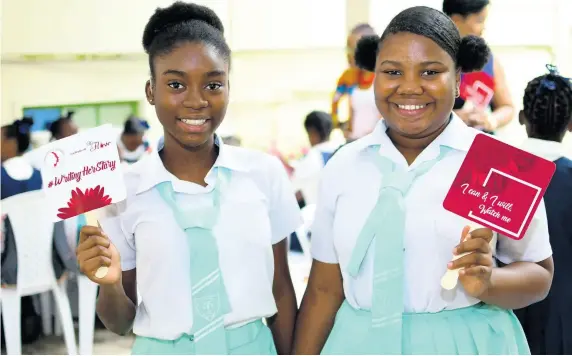  ??  ?? Mckayla Fitzgerald and Kalea Williams from Lister Mair/Gilby School for the Deaf pose with their affirmatio­n fans at the Writing HERStory Conference, held at the Institute of Jamaica. They were among 100 girls between ages 10 and 14 years who benefited from the event, which focused on youth empowermen­t, personal developmen­t and menstrual education.