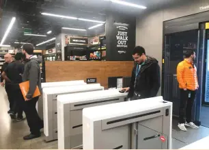  ?? (Jeffrey Dastin/Reuters) ?? A SHOPPER scans a smartphone app associated with his Amazon account and credit-card informatio­n to enter the Amazon Go store in Seattle last week.