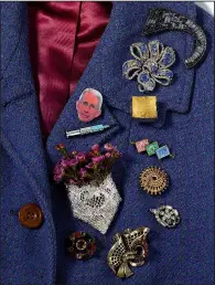  ?? (The New York Times/David Lewis Taylor) ?? An assortment of brooches old and new includes a pin of Dr.
Anthony Fauci.