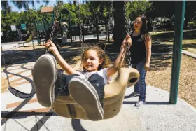  ?? Photos by Gabrielle Lurie / The Chronicle ?? Left: Rivero pushes her 5-year-old daughter, Henny, on a swing at a San Jose Park.