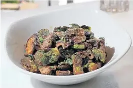  ?? AMY BETH BENNETT/SUN SENTINEL ?? Crispy Brussels sprouts at Grille 66 & Bar in Fort Lauderdale are made with sauteed mushrooms in a soy ginger glaze.