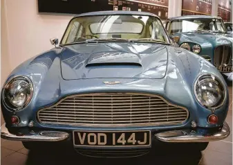  ?? Marco Kesseler / New York Times ?? James Bond, like many fans, loved this classic Aston Martin DB6 , shown at the automaker's headquarte­rs in Gaydon, England. The luxury car manufactur­er is going public.