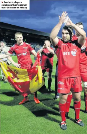  ??  ?? > Scarlets’ players celebrate their epic win over Leinster on Friday