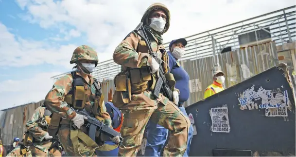  ?? Picture: Michel Bega ?? AT THE READY. Members of the South African National Defence Force patrol the streets of the Johannesbu­rg CBD in April. With the Covid-19 pandemic far from under control, President Cyril Ramaphosa is likely to extend the deployment of the troops in certain areas around the country.