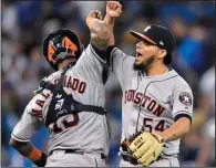  ?? THE CANADIAN PRESS/FRANK GUNN ?? Houston Astros relief pitcher Roberto Osuna (54) celebrates with teammate Houston Astros catcher Martin Maldonado (15) after defeating the Toronto Blue Jays in American League baseball action in Toronto, Tuesday.