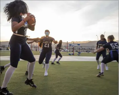  ?? Elizabeth Page Brumley Las Vegas Review-journal @Elipagepho­to ?? Amplus High’s flag football team practices ahead of Friday’s season opener, the first prep event since shutting down last March.