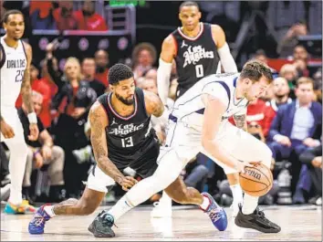  ?? Robert Gauthier Los Angeles Times ?? PAUL GEORGE chases Dallas’ Luka Doncic, who had 32 points, nine assists and six rebounds as the Mavs beat the Clippers 96-93 in Game 2. The Clippers hit just 36.8% of their shots and 26.7% of their three-pointers.