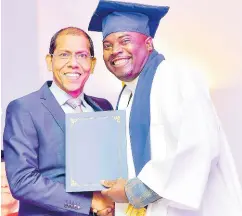  ?? ?? Shawn DaCosta (left), Chief Operating Officer at Sandals Resorts, presents Shawn Thomas, assistant food and beverage manager at Beaches Ocho Rios with his diploma.