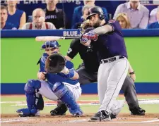  ?? CHARLIE RIEDEL/ASSOCIATED PRESS ?? Cleveland’s Mike Napoli hits an RBI double against Toronto last week. Napoli was rooting for the Cubs in the NLCS.