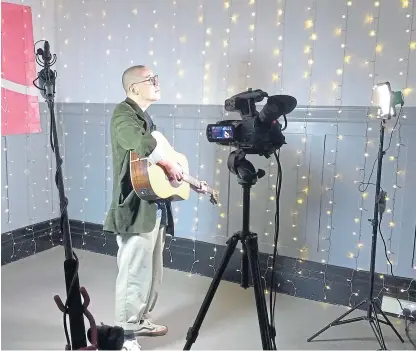  ??  ?? Above: Local musician Blair Davie preparing to perform his live set. Right: Denis Lawson backed the festival.