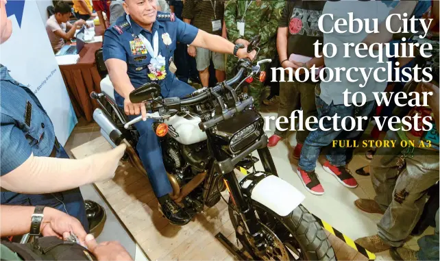  ?? SUNSTAR FOTO/ ARNI ACLAO ?? BIKER BATO. PNP Chief Ronald “Bato” de la Rosa, who will soon retire, checks out the feel of a military motorcycle on display at a gun show in Cebu City. Story on A7.