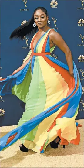  ?? JORDAN STRAUSS/INVISION ?? Tiffany Haddish of “The Last O.G.” twirls a flowing Prabal Gurung rainbow dress.