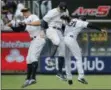  ?? JULIE JACOBSON — THE ASSOCIATED PRESS ?? New York Yankees left fielder Giancarlo Stanton (27), right fielder Aaron Judge, center, and center fielder Aaron Hicks (31) celebrate after they defeated the New York Mets in a baseball game, Saturday in New York.