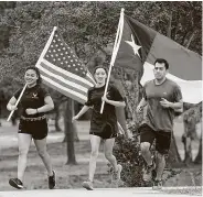  ?? Melissa Phillip / Staff photograph­er ?? U.S. Air Force recruits Jolle Villarosa, from left, Haley Bergeron and Christian Aguilar run in Meyer Park as part of the Houston Run for The Fallen on Sunday in Spring.
