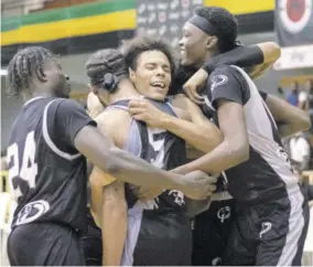  ?? (Photo: Javan Javarie Sutherland) ?? A jubilant Storm team celebrate their defeat of favoured Waves in the semi-finals of the Caribbean Basketball Winter League at the National Arena on Friday.