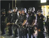  ?? Chris Preovolos / Hearst Newspapers ?? Police form a line between protesters and Vallejo police headquarte­rs during a protest Friday after the June 2 killing of Sean Monterrosa by police.