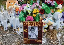  ?? PHIL MASTURZO / BEACON JOURNAL ?? A photo of Azeria Tucker is among items placed at a memorial at the scene of her death. In July, the 1-year-old and her father, Horace Lee, 43, were intentiona­lly struck and killed by a vehicle, Akron police said. Police charged a 36-year-old Canton man in the deaths.