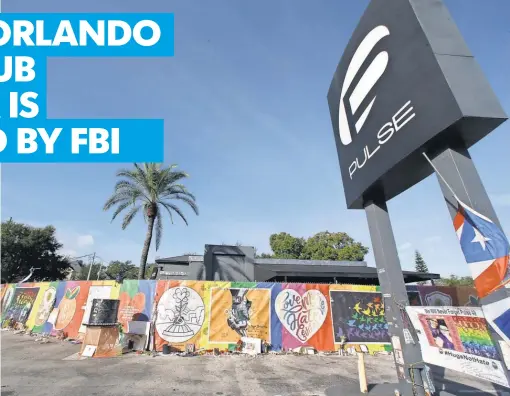  ?? JOHN RAOUX, AP ?? Artwork covers a fence around the Pulse nightclub, where 49 people were killed in amass shooting in June.