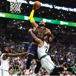  ??  ?? BOSTON CELTICS guard Isaiah Thomas (right) tries to wrap up Cleveland Cavaliers superstar LeBron James on his way to the hoop during Wednesday night’s Game 1 of the Eastern Conference Finals at the TD Garden. James scored a game-high 38 points and...