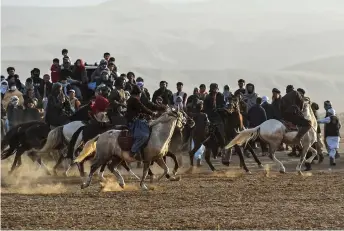  ?? ?? Horsemen competing during buzkashi.