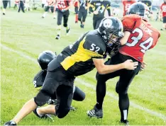  ?? ED TELENKO/SPECIAL TO POSTMEDIA NEWS ?? West Niagara Steelers defender Jaxon Austin, left, tackles Fort Erie Longhorns back Kaiden Craft in bantam football at Westlane Secondary School Sunday in Niagara Falls.