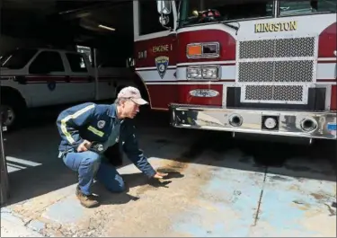  ?? TANIA BARRICKLO — DAILY FREEMAN ?? City of Kingston Engineer Ralph Swenson talks about damage to floor of Central Fire Department due to salt, ice and water damage.