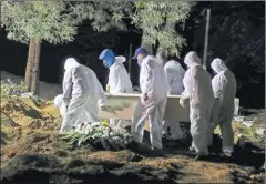  ?? PICTURE: REUTERS ?? Gravedigge­rs carry a coffin as spotlights illuminate the graves during a night burial at Vila Formosa cemetery, amid the coronaviru­s disease (COVID-19) pandemic, in Sao Paulo, Brazil on April 28, 2021.