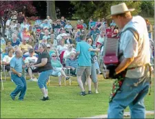  ?? MEDIANEWS GROUP FILE PHOTO ?? Band leader Pete Eshelman plays the accordion as people dance to a Concert Sundaes performanc­e by ZydecoA-Go-Go in Wile Avenue Park in 2010.