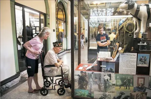  ?? Stephanie Strasburg/Post-Gazette photos ?? Janet Interthal, 64, of Ross, left, looks at military items with her father, World War II Navy veteran Bernie Stephan, 88, of Millvale, as they observe Memorial Day together on Monday at Soldiers & Sailors Memorial Hall & Museum in Oakland.