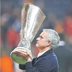  ?? — Reuters photo ?? Manchester United manager Jose Mourinho celebrates with the trophy after winning the Europa League final.