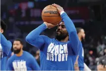  ?? The Associated Press ?? Dallas Mavericks guard Kyrie Irving smiles as he warms up prior to a game against the Los Angeles Clippers Wednesday in Los Angeles.