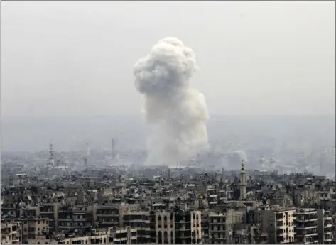  ?? AP PHOTO ?? Smoke rises following a Syrian government air strike on rebel positions Monday in eastern Aleppo, Syria. The government seized large swaths of the Aleppo enclave under rebel control since 2012 in the offensive that began last week.