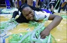 ?? Associated Press ?? Theresa Onwuka slides on the floor in celebratio­n Saturday after Buffalo won the Mid-American Conference’s automatic NCAA bid in Cleveland.