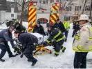  ?? Photograph: Jeffrey Hastings ?? Firefighte­rs rescue the woman from the garbage truck in Manchester, New Hampshire, on Monday.