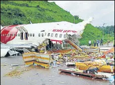  ?? ANI ?? Officials inspect the wreckage of the Air India Express flight at the Kozhikode Internatio­nal Airport on August 8.