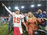  ?? MATT SLOCUM/AP ?? QB Patrick Mahomes leaves the field with his wife, Brittany, after leading the Chiefs to a 38-35 comeback victory over the Eagles in the Super Bowl on Sunday.