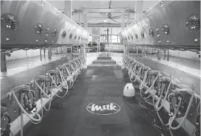  ?? JAMES MACDONALD/BLOOMBERG FILES ?? Automated milking machines at an Ontario dairy farm. The Dairy Farmers of Canada says attacks on the industry “are founded more on rhetoric than fact.”