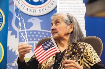  ?? ADOLPHE PIERRE-LOUIS/JOURNAL ?? Eva Saumell Del Castillo, a 103-year-old native of Cuba, clutches a U.S. flag and festive balloons after becoming a newly-minted American citizen during a ceremony at the U.S. Citizenshi­p and Immigratio­n Services office in Albuquerqu­e on Monday.