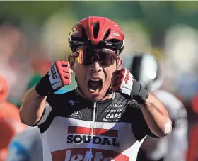  ?? BENOIT TESSIER/POOL VIA AP ?? Australia’s Caleb Ewan celebrates Monday as he crosses the finish line to win the third stage of the Tour de France.