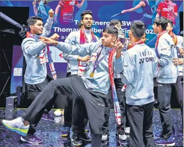  ?? BADMINTONP­HOTO/BWF ?? India players celebrate on the podium after receiving the Thomas Cup in Bangkok on Sunday.