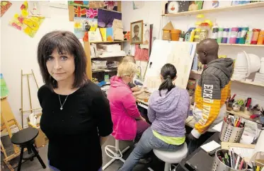  ?? GREG SOUTHAM/ EDMONTON JOURNAL ?? Marie Renaud, executive director of the Lo-Se-Ca Foundation, with some of the people with developmen­tal disabiliti­es who use the non-profit’s facility in St Albert.