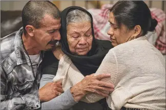  ??  ?? From left, Adrián Luna’s brother Alfredo, his mother Jesús de Maria, and his sister-in-law Elia comfort each other July 25 after learning that Luna’s remains had been positively identified.