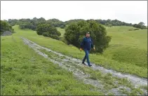  ??  ?? Linus Eukel, executive director of the John Muir Land Trust, walks along a trail at Fernandez Ranch in Martinez recently.